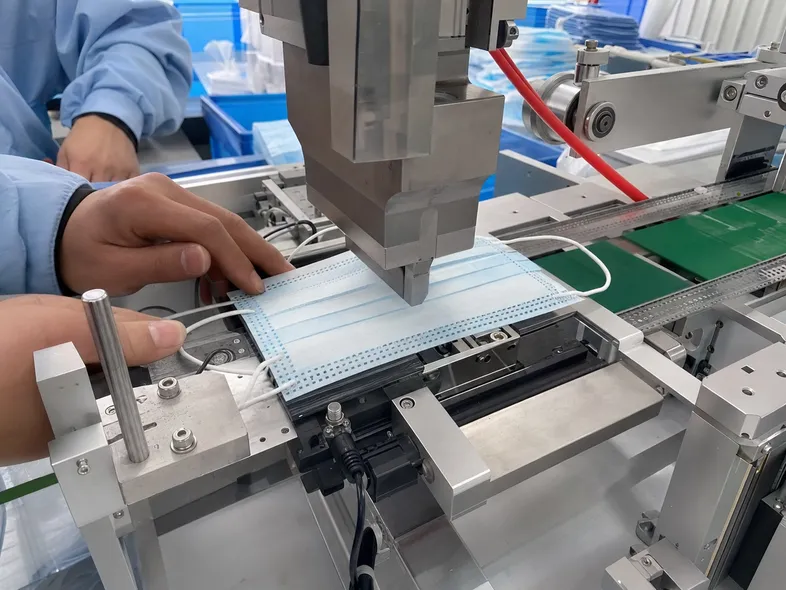 Ultrasonic welding process attaching ear loops to the mask face panel