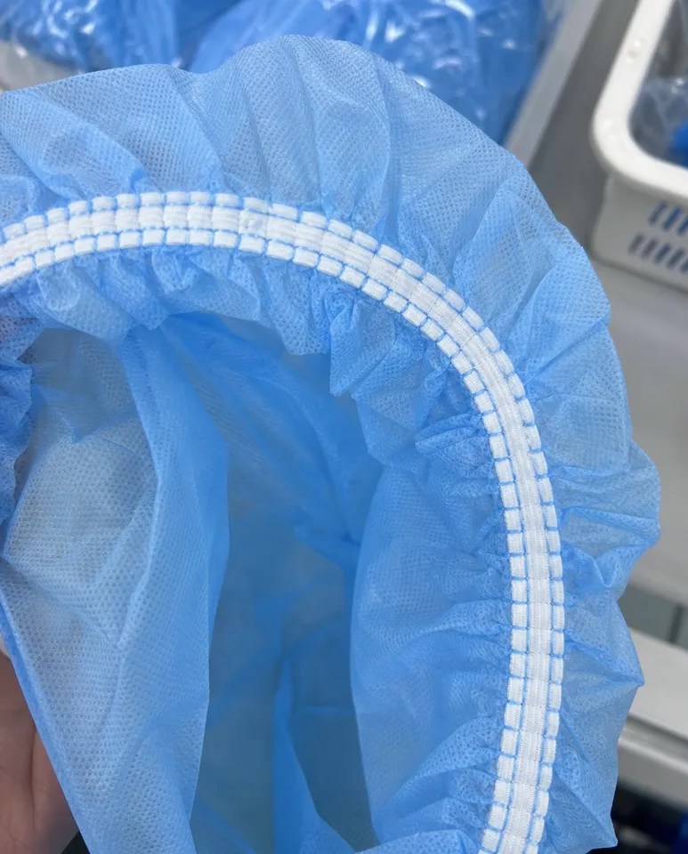 Close-up of sewn-in elastic band construction on bouffant medical cap showing consistent stitching around full circumference