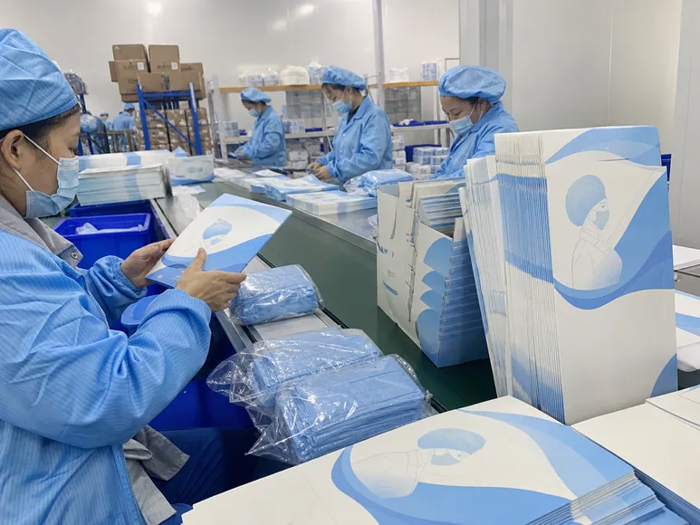 Custom private-label medical cap packaging with branded artwork on production line