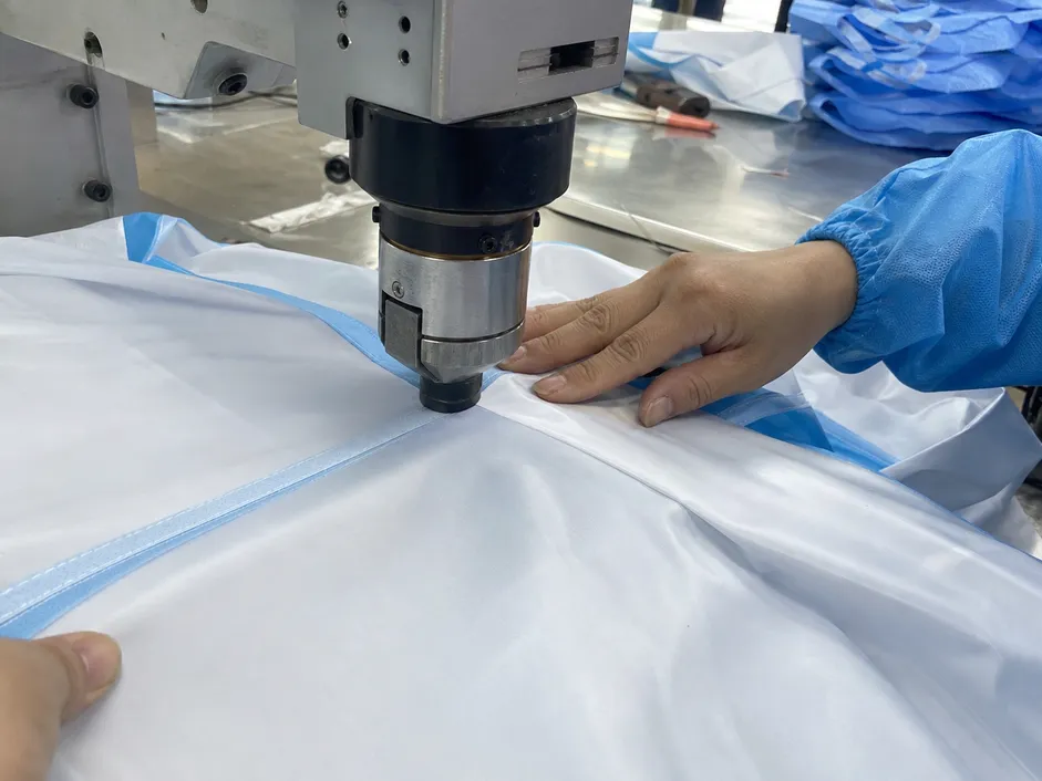 Ultrasonic seam welding process on protective clothing fabric showing continuous bond without needle holes