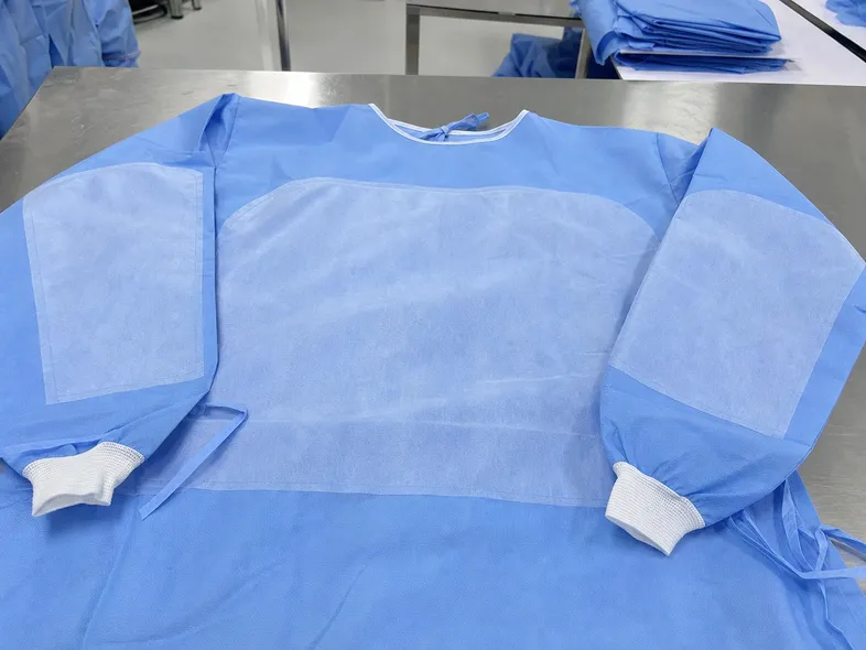 Reinforced lamination zones on chest and sleeve areas of Level 3-4 isolation gown