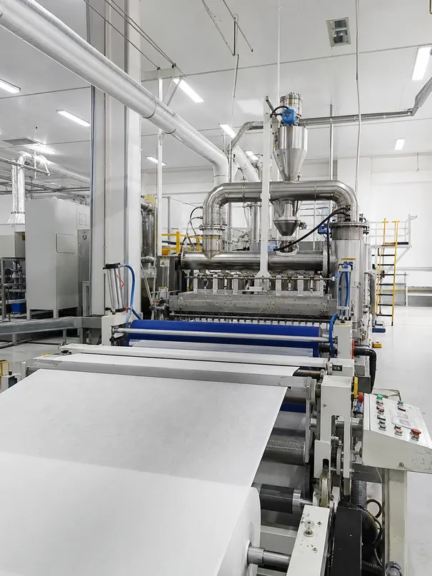 In-house SMS nonwoven fabric production line showing meltblown layer extrusion