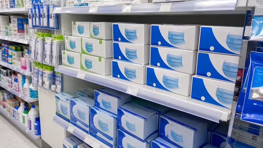 Retail pharmacy shelf display with medical mask boxes in consumer packaging