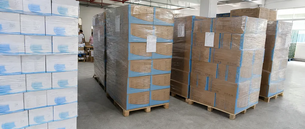 Surgical mask pallets staged for hospital, government, and distributor shipment channels