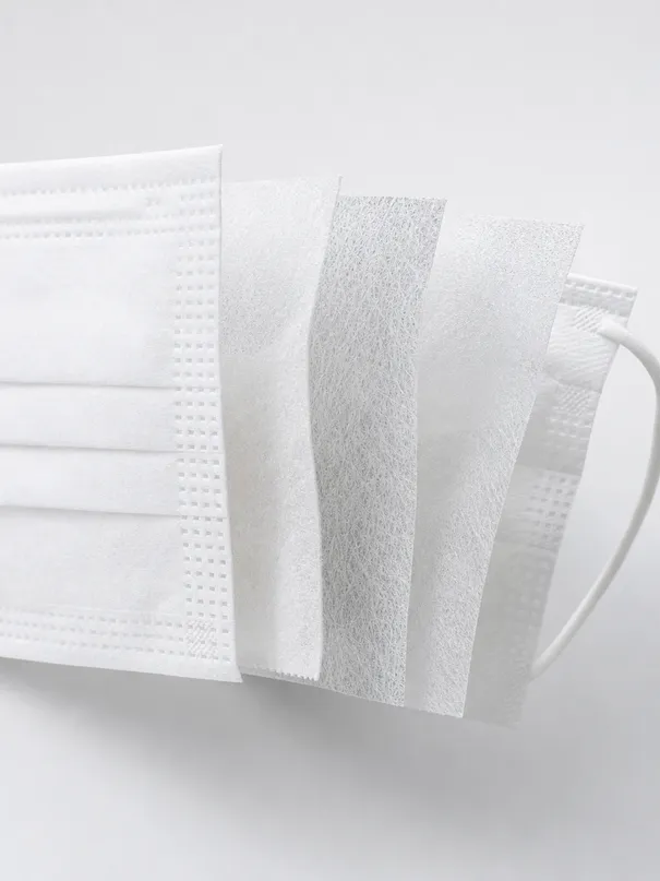 Cross-section view of 5-layer N95 surgical mask construction showing spunbond and meltblown layers